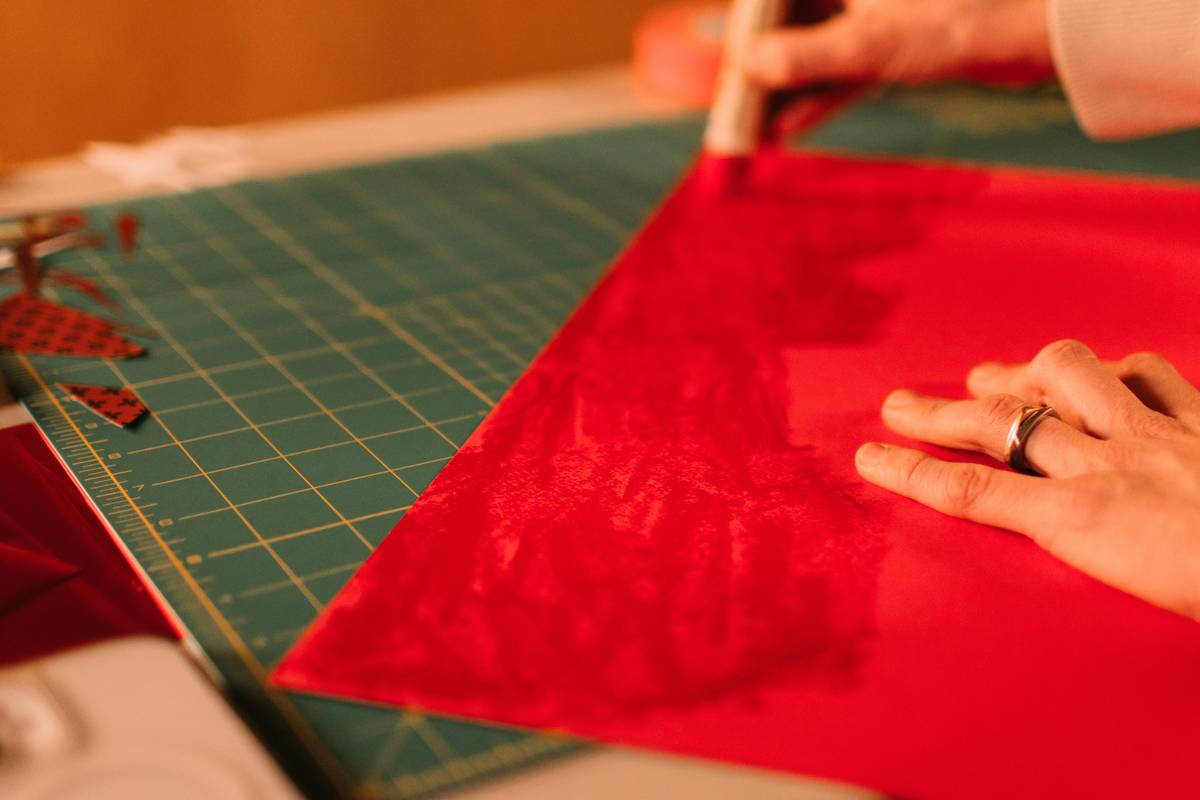 DIY workspace showing fabric, scissors, and finished table linen placemat how to make example